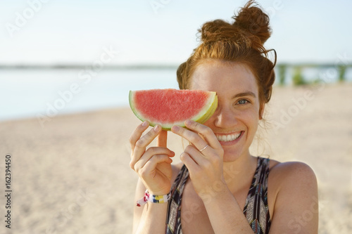 Cute young woman with a slice of watermelon