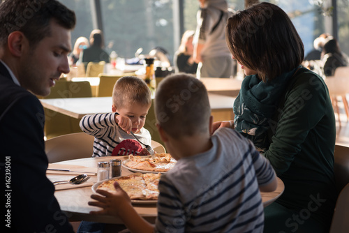 Young parents enjoying lunch time with their children