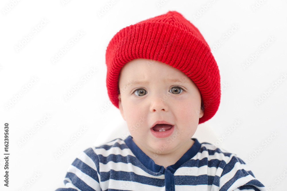 Kid in red hat is indignant two first teeth studio Kid in red hat is indignant two first teeth studio
