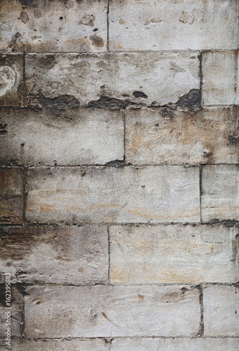 Wall of gray travertine adarce stone bricks
