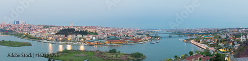 Istanbul city view from Pierre Loti Teleferik station overlooking Golden Horn with Halic Bridge, Golden Horn Metro Bridge and historical mosques at dusk time, Eyup District, Istanbul, Turkey
