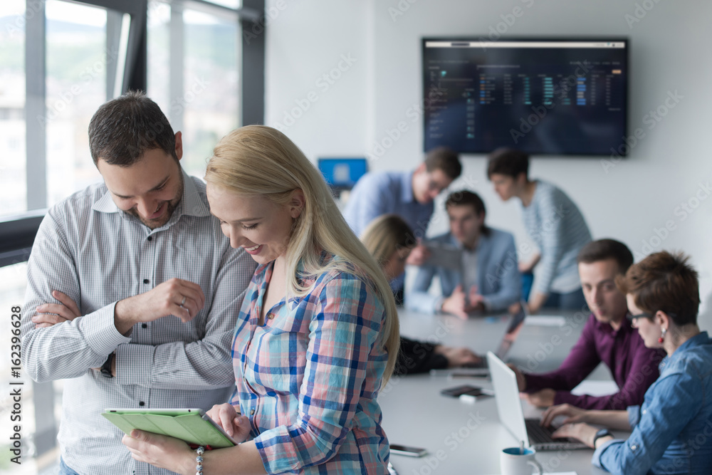 Two Business People Working With Tablet in office Two Business People Working With Tablet in office