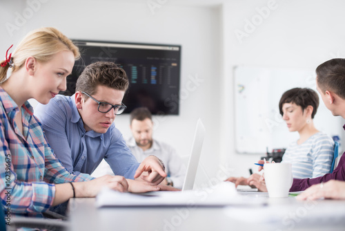 Two Business People Working With laptop in office