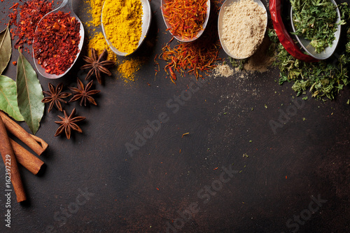 Fototapeta Naklejka Na Ścianę i Meble -  Various spices spoons on stone table