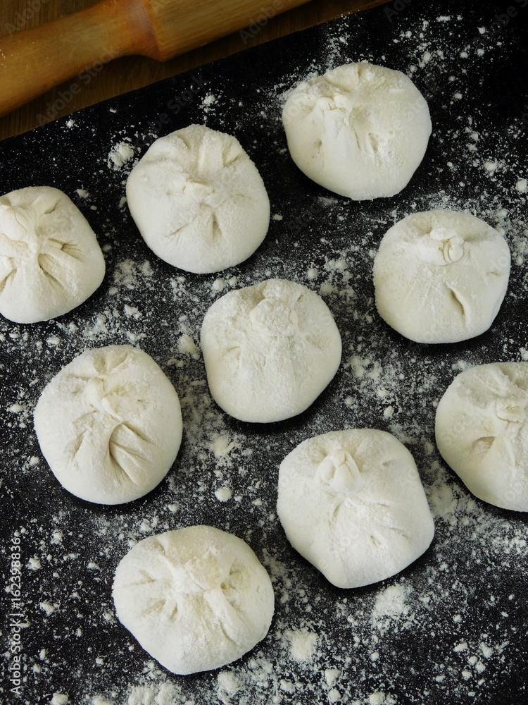 Raw khinkali, Georgian traditional dish, covered with flour