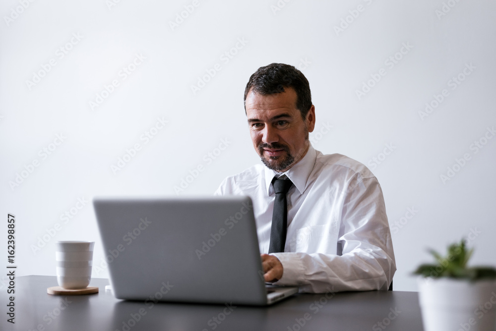 Elegant businessman analyzing data in office Elegant businessman analyzing data in office