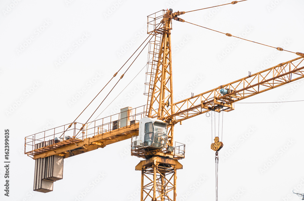 Cab lifting crane in the construction site. Cab lifting crane in the construction site.