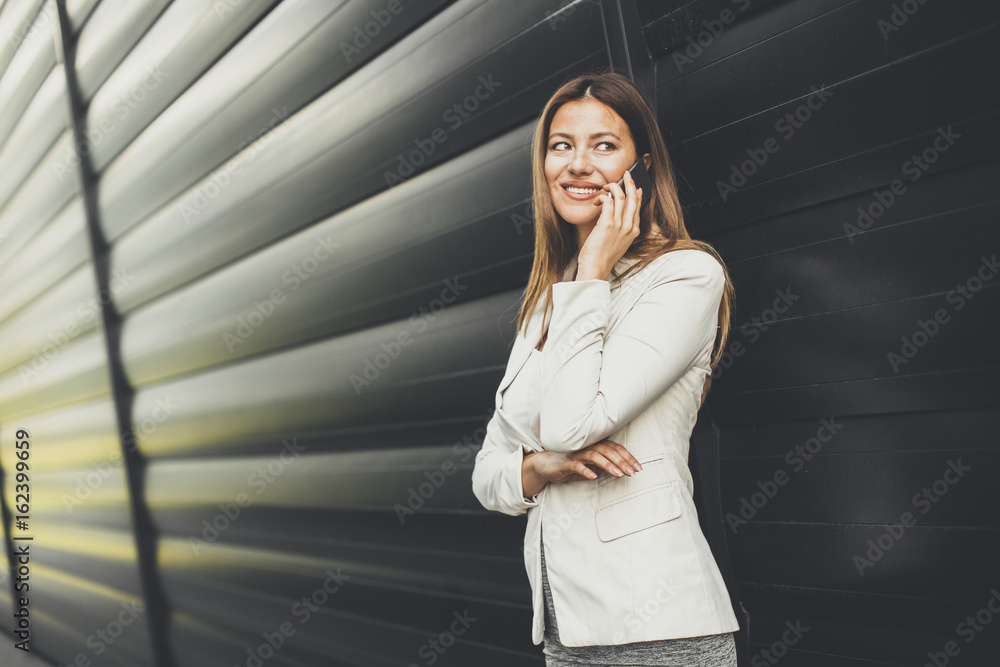 Fototapeta premium Pretty businesswoman using smart phone