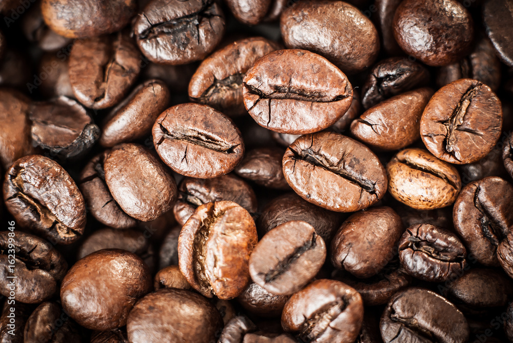 Naklejka premium Coffee beans concept on wooden table background.