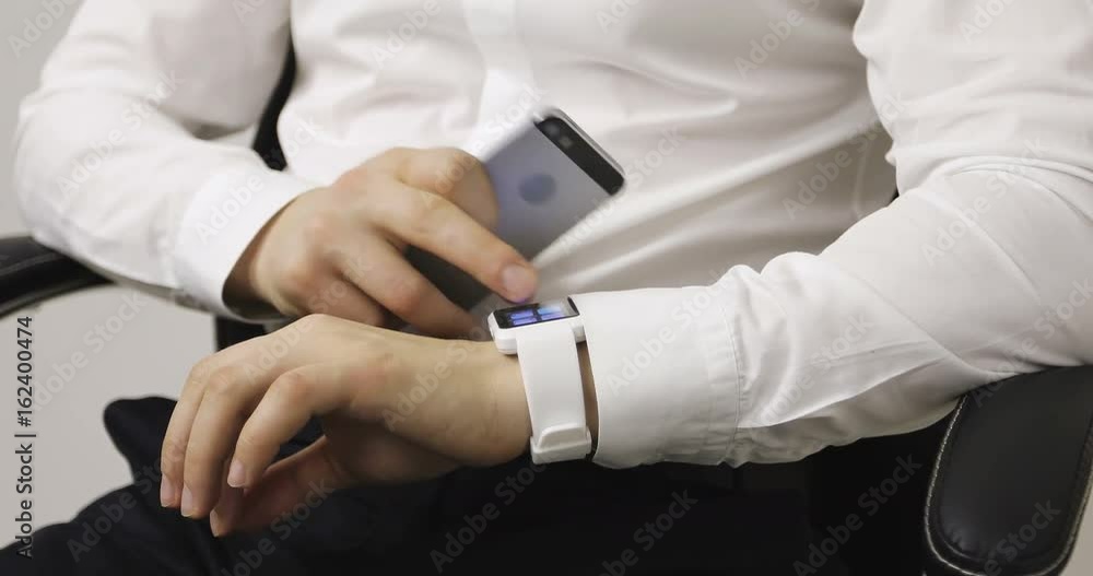 4K Smartphone cell and a smartwatch being connected together and used. 4K Smartphone cell and a smartwatch being connected together and used.