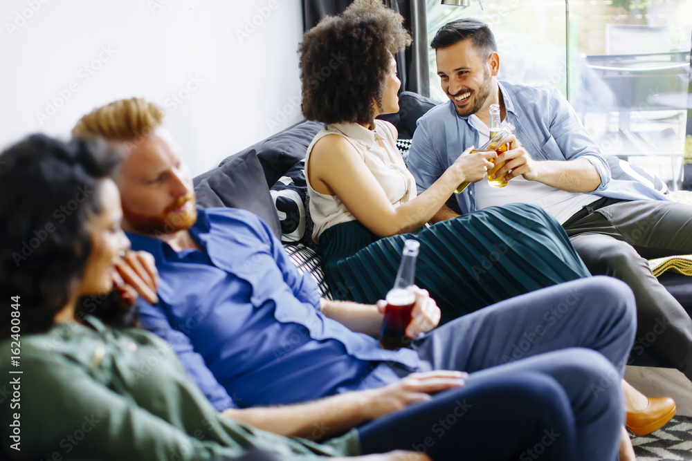 Group of friends watching TV, drinking cider and having fun Group of friends watching TV, drinking cider and having fun