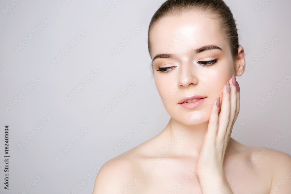 Portrait of a girl with natural make-up and microblending eyebrows close-up. Accurate eyelashes and gently pink lips, clean skin, shining Portrait of a girl with natural make-up and microblending eyebrows close-up. Accurate eyelashes and gently pink lips, clean skin, shining