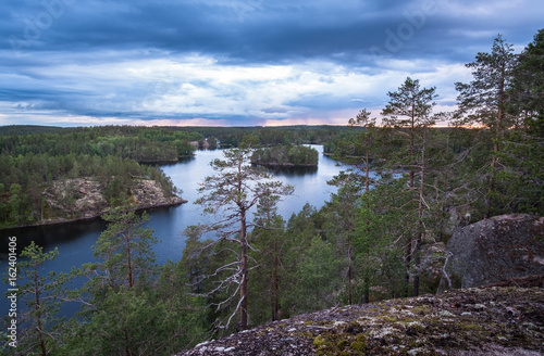 Scenic landscape with lake and storm clouds at summer evening in Repovesi  National Park. Finland