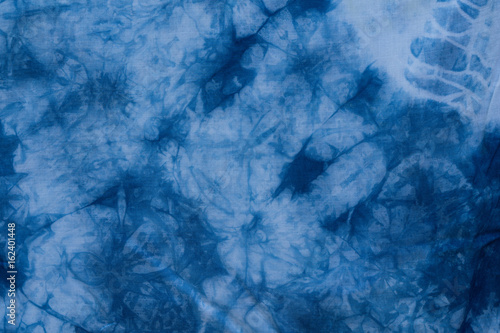 Pattern of blue tie batik dye on cotton cloth, Dyed indigo fabric background and textured, Painted blue watercolor on white cotton cloth