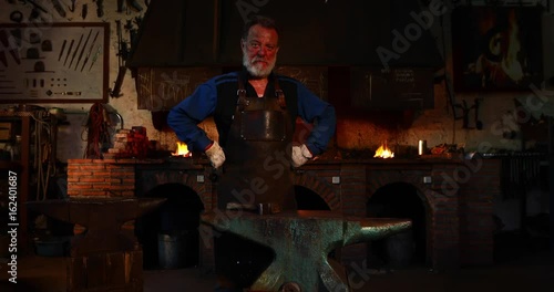 Portrait of confident blacksmith in his workshop