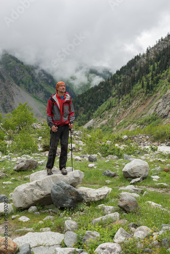Bearded man traveler stands in the mountain gorge © sanechka