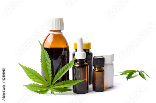 Fototapeta Naklejka Na Ścianę i Meble -  Marijuana and cannabis oil bottles isolated