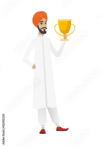 Hindu businessman holding a trophy.