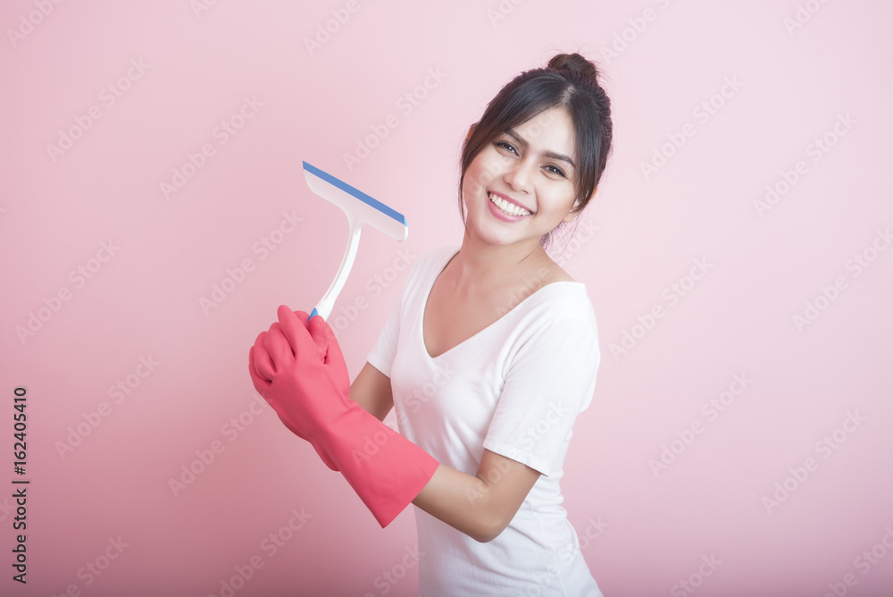 Beautiful asian housewife smiling on pink background Beautiful asian housewife smiling on pink background