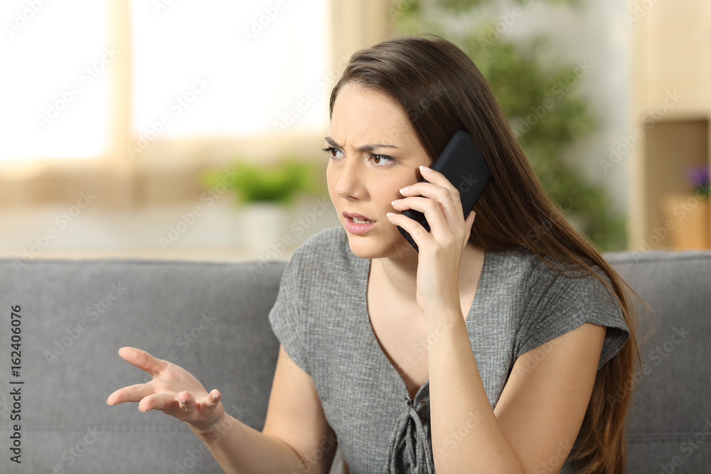 Angry woman arguing during a phone call Angry woman arguing during a phone call
