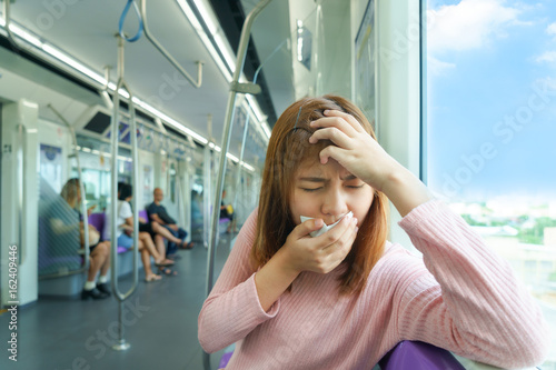 Fotografie Portrait of young woman headache or carsick while taking the sky train