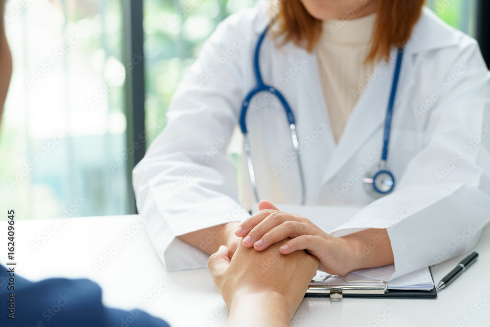 Female doctor holding patient hands for cheerful. Female doctor holding patient hands for cheerful.
