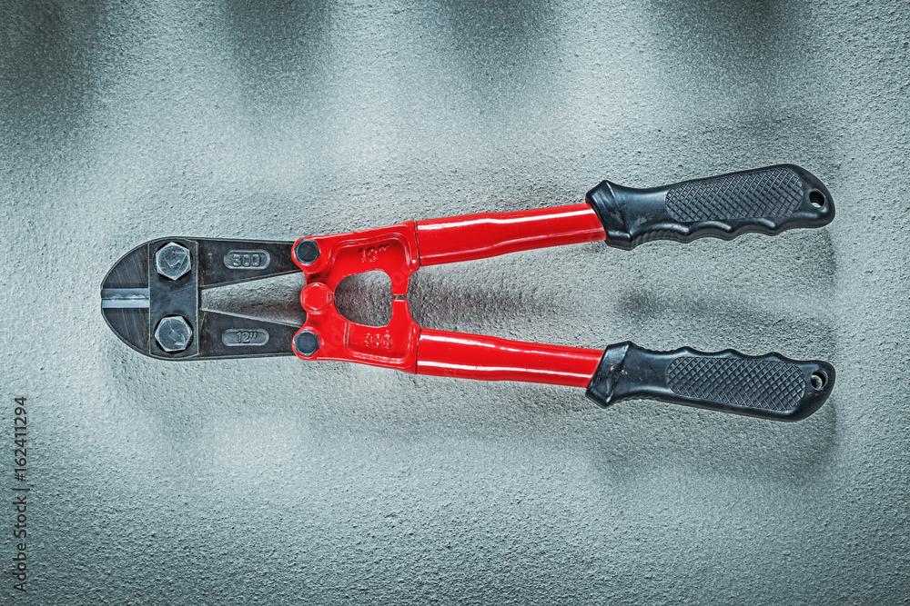 Bolt cutter on concrete surface construction concept Bolt cutter on concrete surface construction concept