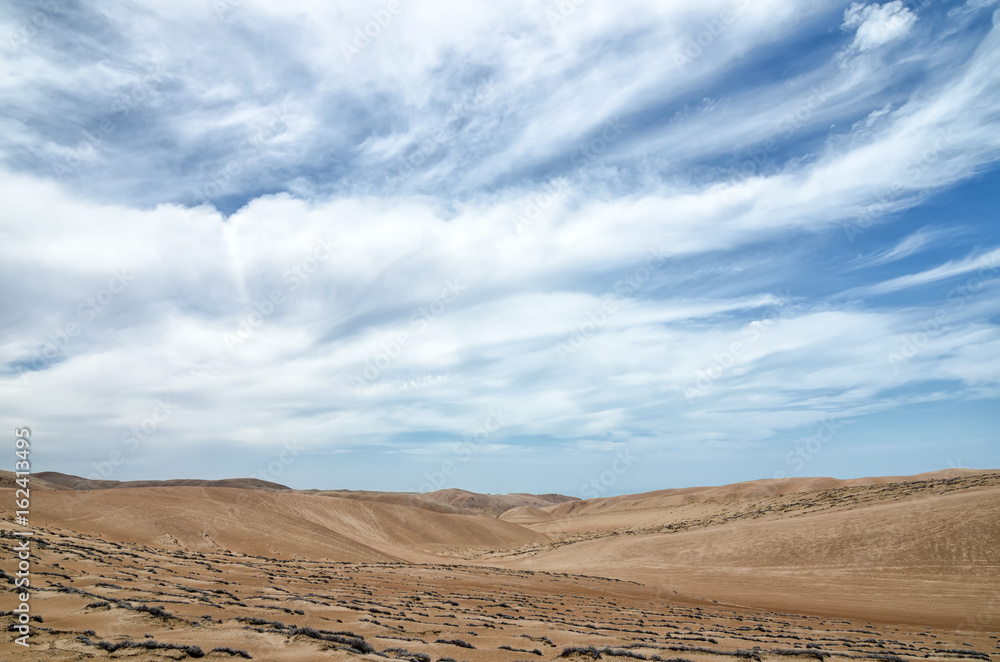 Stunning view to the desert under blue cloudy sky