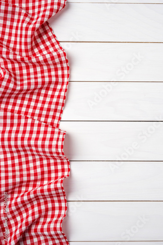 Red checkered tablecloth over white wooden table