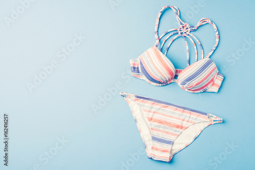 Fotografie, Obraz Colorful swimsuit on blue background