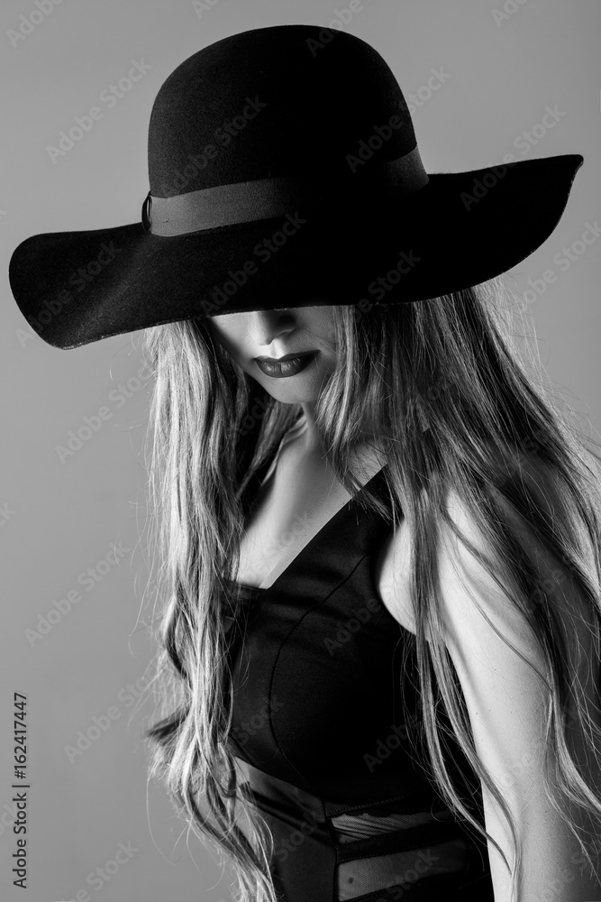Black and white portrait of beautiful sexy woman in black hat Black and white portrait of beautiful sexy woman in black hat