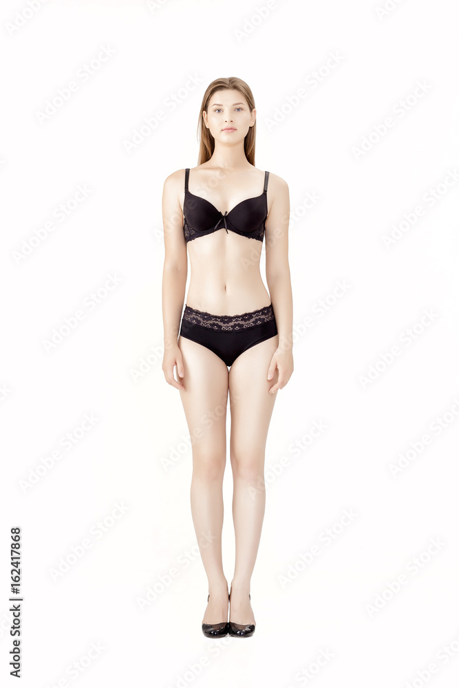 Young slender woman in black lingerie isolated on white background Young slender woman in black lingerie isolated on white background