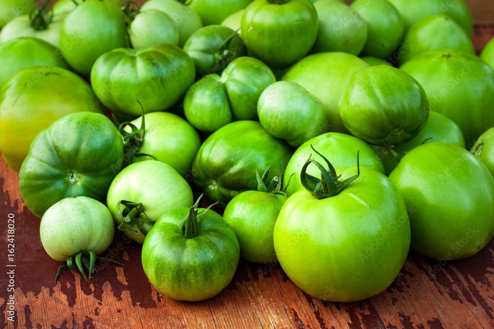 Immature Green Tomatoes On Wooden Brown Board Top View And Close Up. Immature Green Tomatoes On Wooden Brown Board Top View And Close Up.
