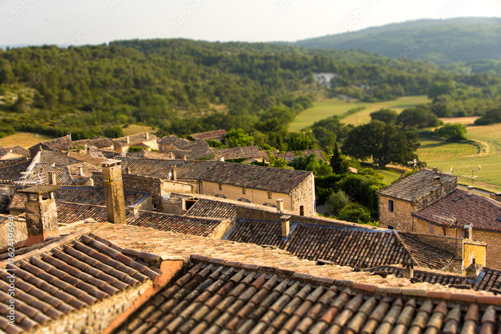 Miniature effect of small provence village on hill in countryside -Roofs in golden sunset – Family trip to France