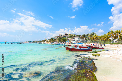 Playa del Carmen - relaxing on chair at paradise beach and city at caribbean coast of Quintana Roo, Mexico photo