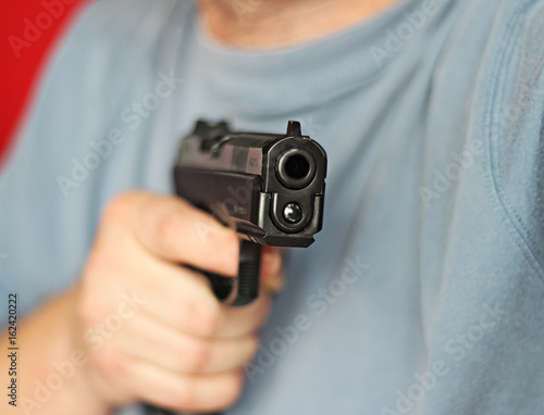 man with hand gun pistol rubber attack violence © milankubicka