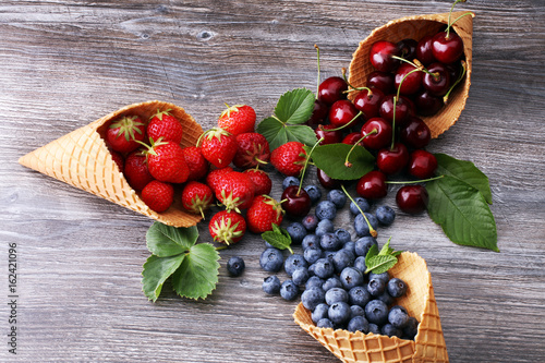 Berries in waffle cones - strawberry, blueberry and black cherry