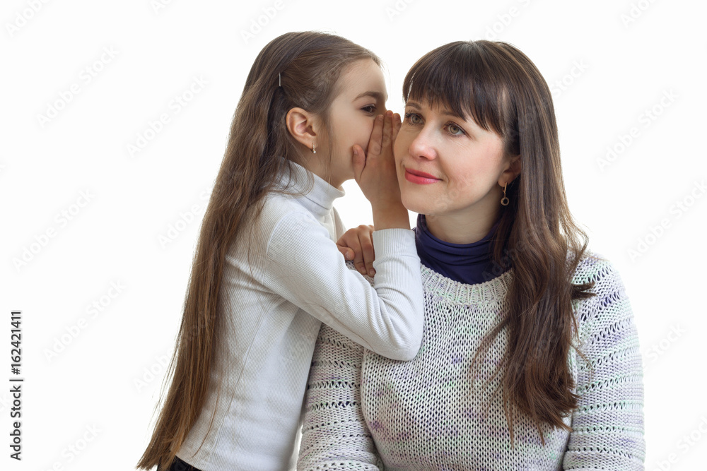 Portrait of a young mother and daughter who sets the secrets on the eyelet is isolated on a white background Portrait of a young mother and daughter who sets the secrets on the eyelet is isolated on a white background