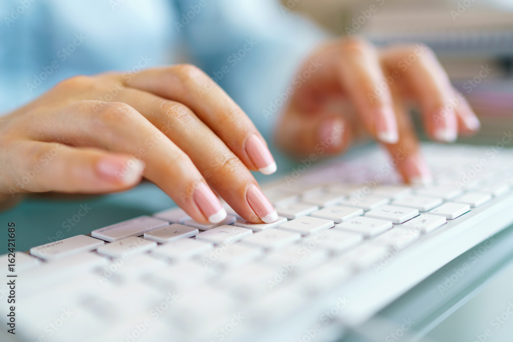 Woman office worker typing on the keyboard Woman office worker typing on the keyboard