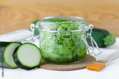 Grated zucchini in a glass jar - natural diy facial mask. Homemade cosmetics.