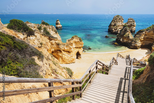 Wooden footbridge to beautiful beach Praia do Camilo near Lagos in aAlgarve region, Portugal