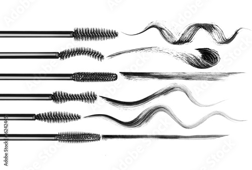 Set of various mascara brushes with mascara strokes on white background photo