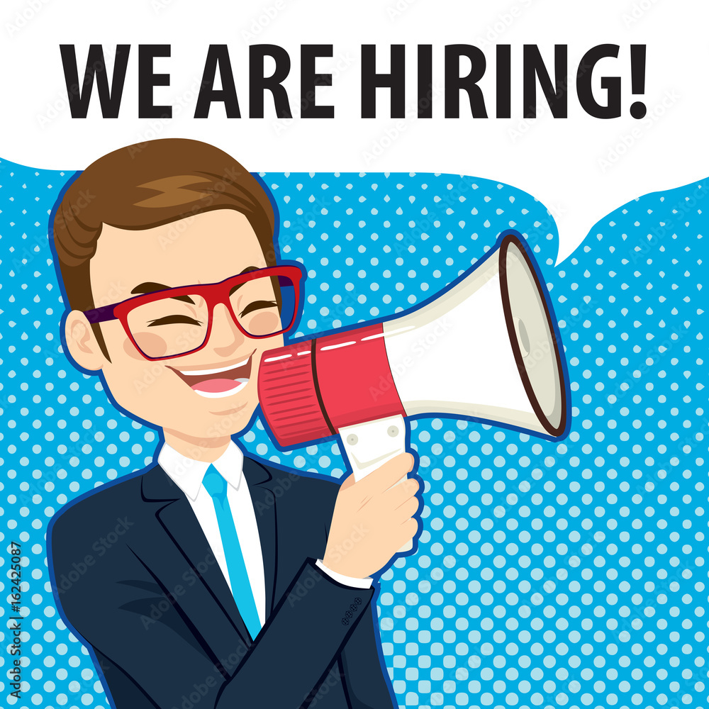 Happy young man wearing glasses speaking with white megaphone and comic balloon with we are hiring text Happy young man wearing glasses speaking with white megaphone and comic balloon with we are hiring text