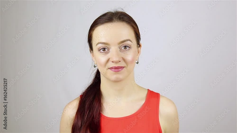 Portrait of a young beautiful woman. Smiling looking at camera. Portrait of a young beautiful woman. Smiling looking at camera.