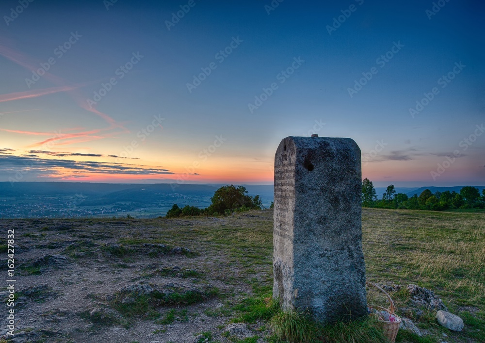 Evening landscape and a mile stone on the famous hill Walberla at the franconian suisse in Bavaria in south Germany