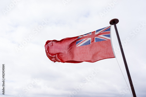 uk red ensign the british maritime flag flown in white sky