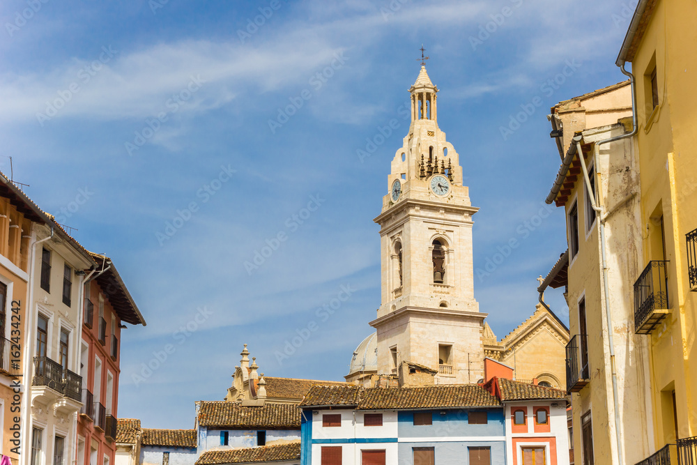 Tower of the Santa Maria church and colorful houses in Xativa