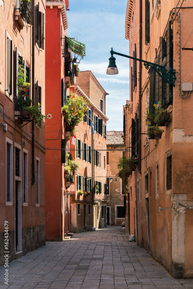 Narrow street in the old town in Venice Italy