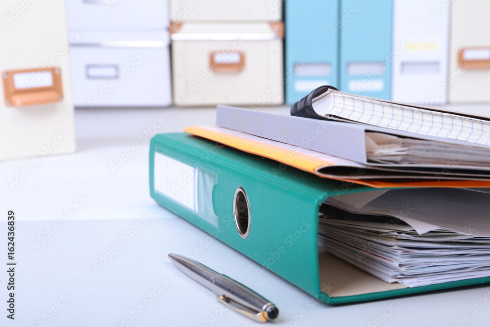 Folder file, note and pen on the desk. blurred background. Folder file, note and pen on the desk. blurred background.