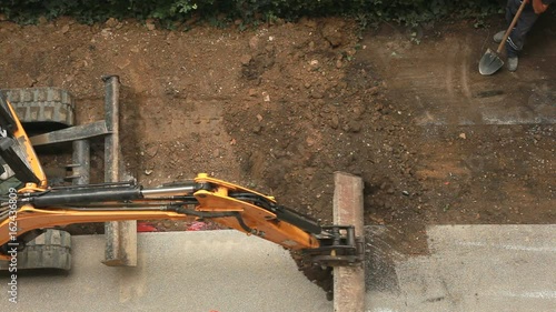 Extracting and loading excavated soil